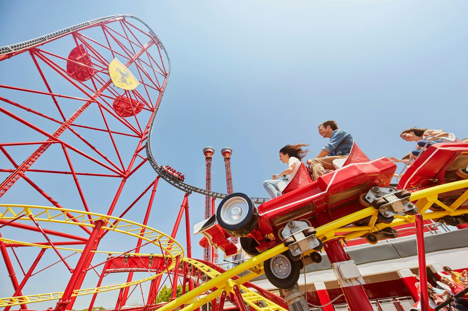 Passengers on a red roller coaster at PortAventura World